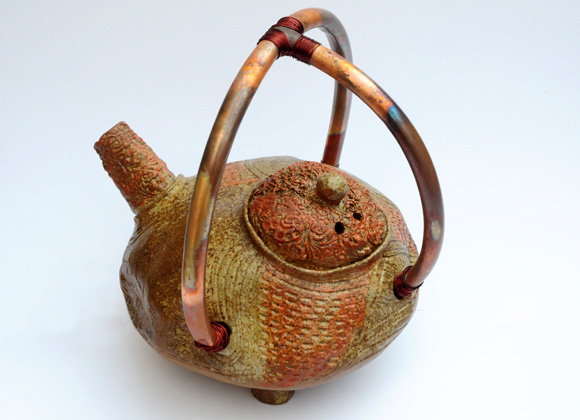Tea pot with copper handle 